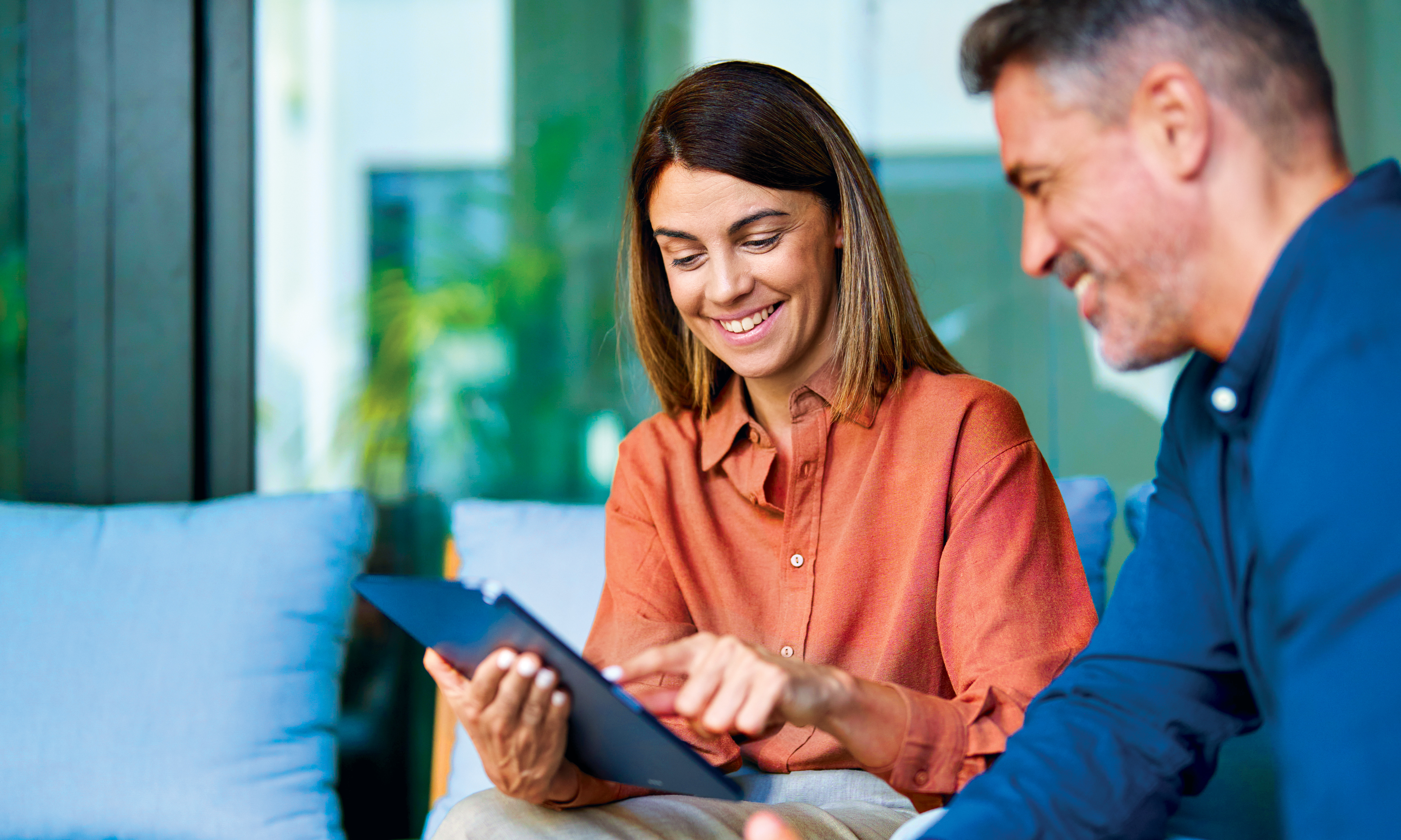 Couple looking at potential build to rent opportunities on tablet