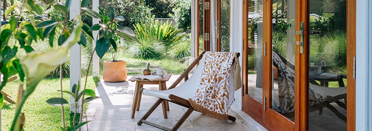 Adirondack chair and coffee table on patio outside French doors